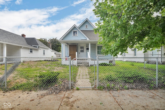 view of front of house featuring covered porch, a fenced front yard, and a gate