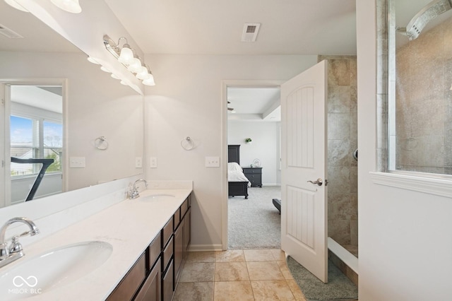 ensuite bathroom with walk in shower, double vanity, ensuite bath, and a sink