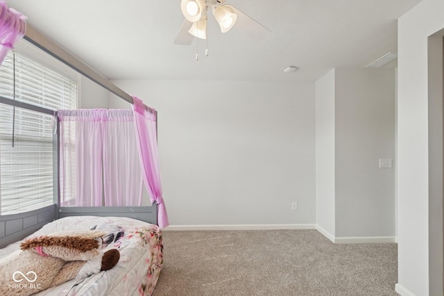 carpeted bedroom featuring baseboards and a ceiling fan