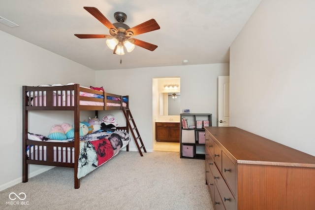 bedroom with baseboards, light carpet, connected bathroom, and visible vents