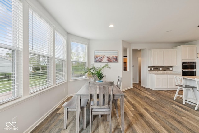 dining space with baseboards, recessed lighting, and dark wood-type flooring