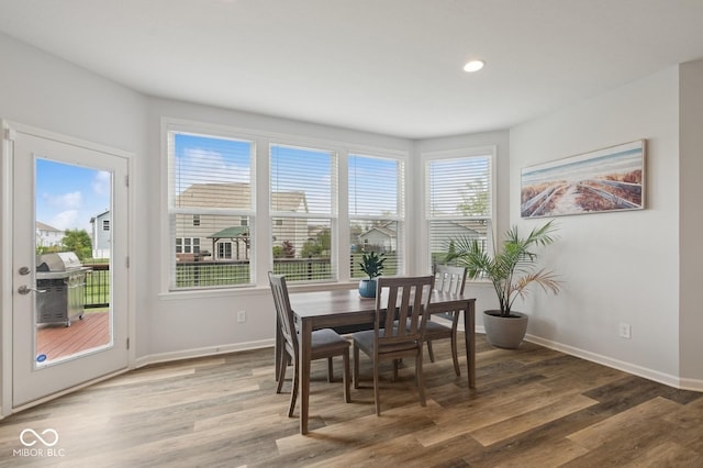 dining space with baseboards, light wood-type flooring, and recessed lighting