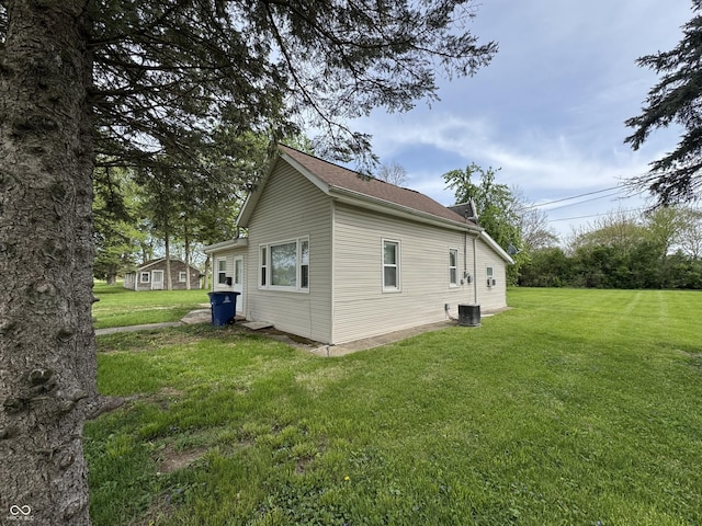 view of property exterior featuring a yard and central AC