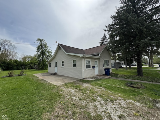 view of side of property with a yard