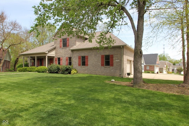 view of front of house featuring a garage, a front lawn, concrete driveway, brick siding, and roof with shingles