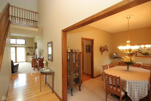 dining room with an inviting chandelier, wood finished floors, and baseboards