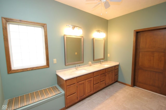 full bathroom with ceiling fan, a sink, and double vanity