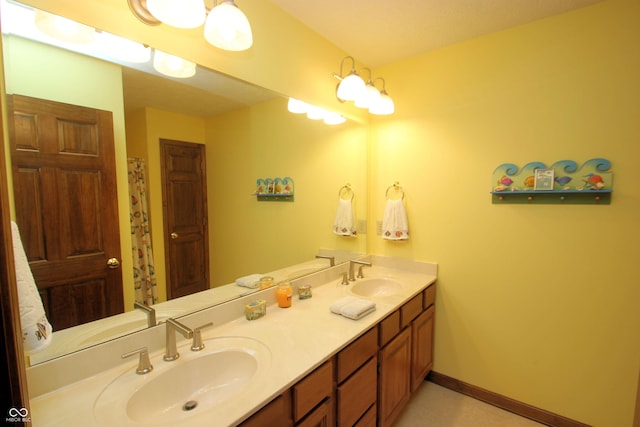 full bathroom with a sink and double vanity