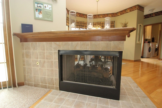 interior details with separate washer and dryer and a multi sided fireplace