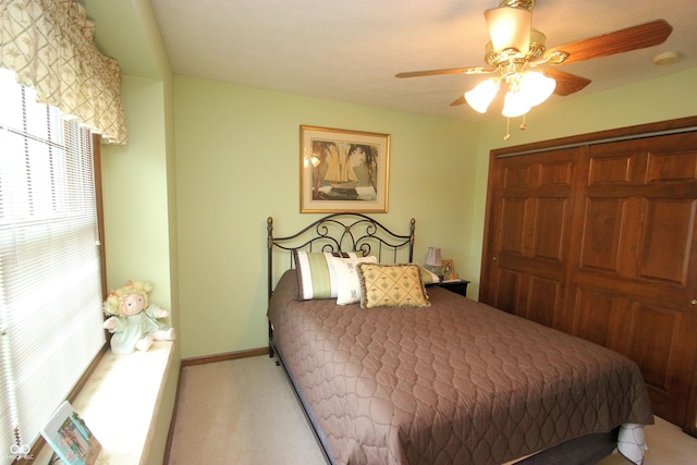 bedroom featuring carpet, a closet, baseboards, and ceiling fan