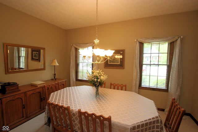 dining space featuring a chandelier and light colored carpet