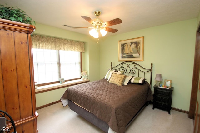 bedroom with light carpet, baseboards, a ceiling fan, and visible vents