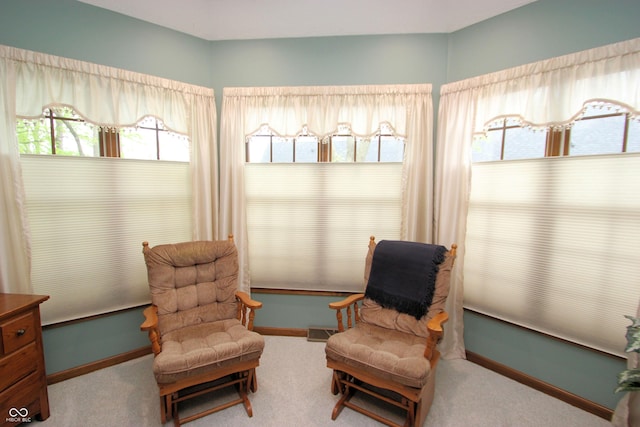 sitting room featuring baseboards and carpet