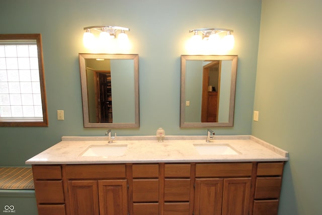 full bathroom featuring double vanity and a sink