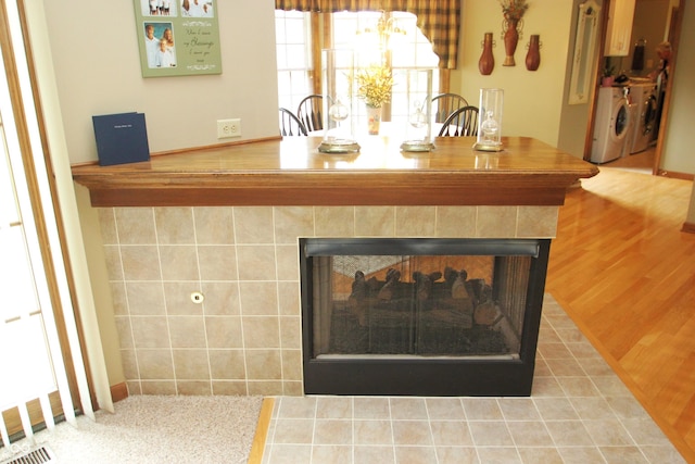 room details with separate washer and dryer and a fireplace