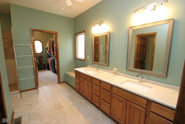 full bath featuring double vanity, visible vents, a ceiling fan, and a sink