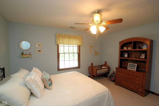 bedroom with light colored carpet, visible vents, and a ceiling fan