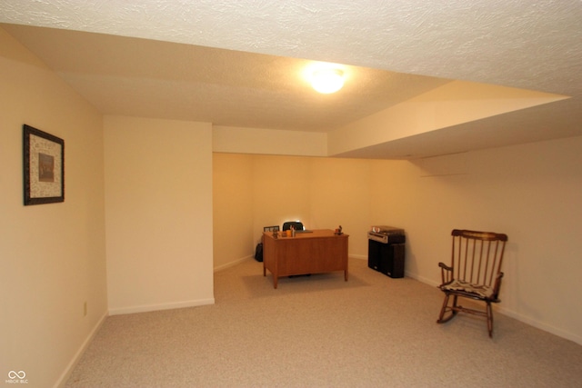 living area with a textured ceiling, baseboards, and carpet floors