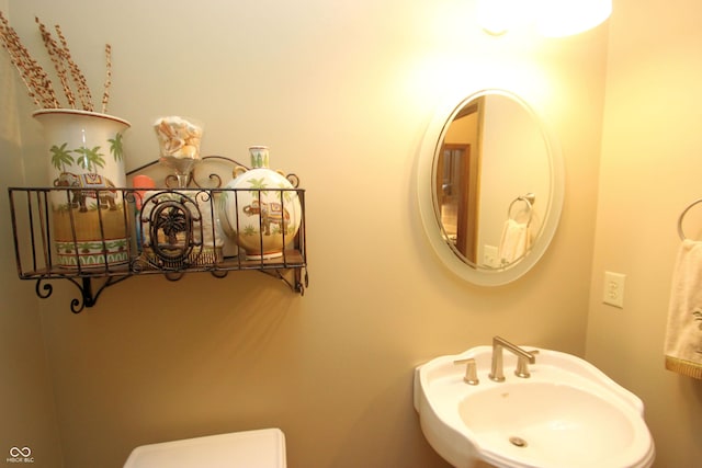 bathroom with toilet and a sink