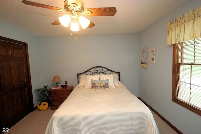 bedroom with carpet, baseboards, and a ceiling fan