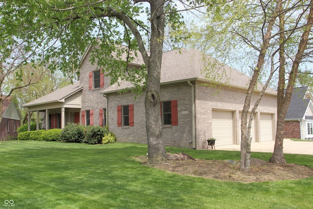 view of front of house featuring an attached garage, brick siding, driveway, and a front yard