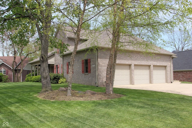 view of front of home with a garage, brick siding, driveway, and a front yard