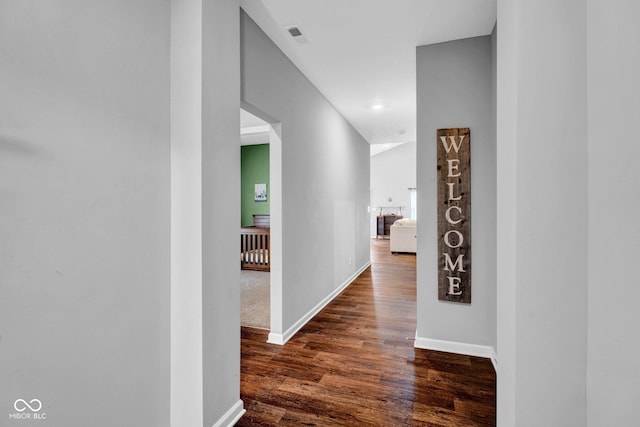 corridor with baseboards, recessed lighting, visible vents, and dark wood-style floors