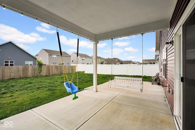 view of patio / terrace featuring a residential view and a fenced backyard