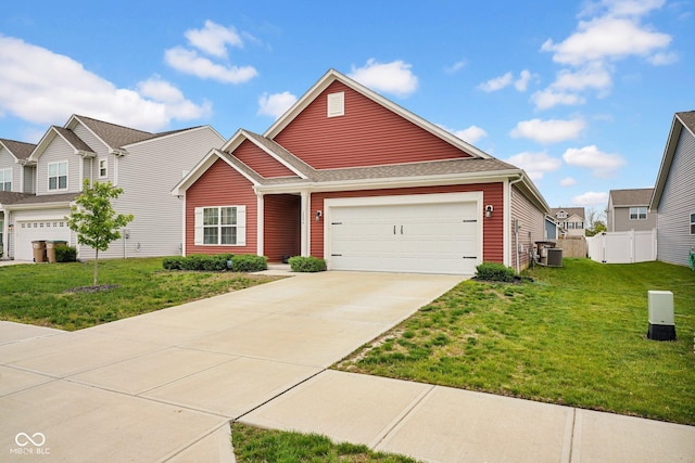 craftsman house featuring driveway, fence, a garage, central air condition unit, and a front lawn