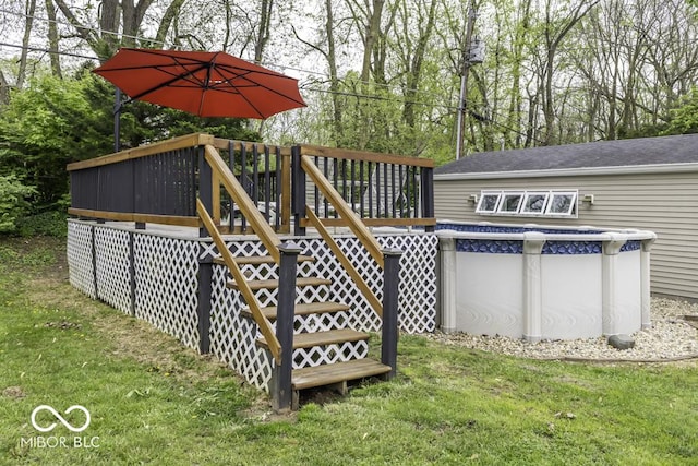 exterior space featuring a lawn, stairway, and a wooden deck
