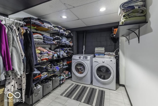 laundry area with separate washer and dryer, laundry area, concrete block wall, and recessed lighting
