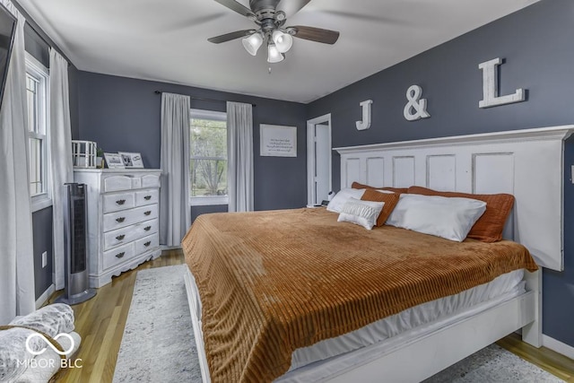 bedroom with ceiling fan and wood finished floors