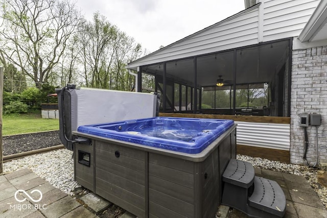 view of patio with a sunroom and a hot tub