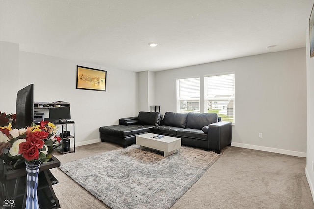 carpeted living room featuring baseboards