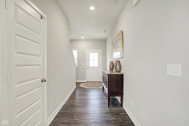 doorway to outside featuring dark wood finished floors, baseboards, and recessed lighting