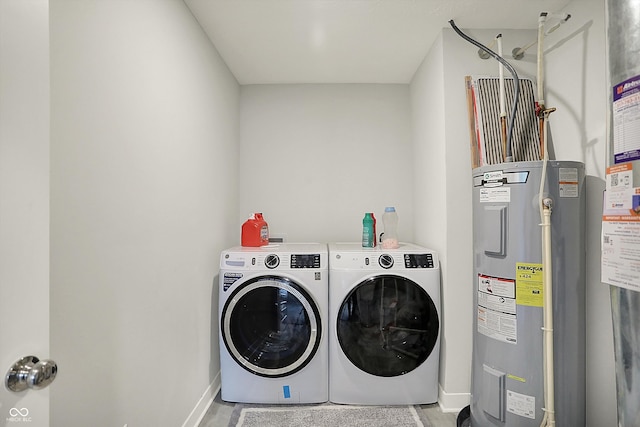 laundry room with electric water heater, baseboards, laundry area, and independent washer and dryer