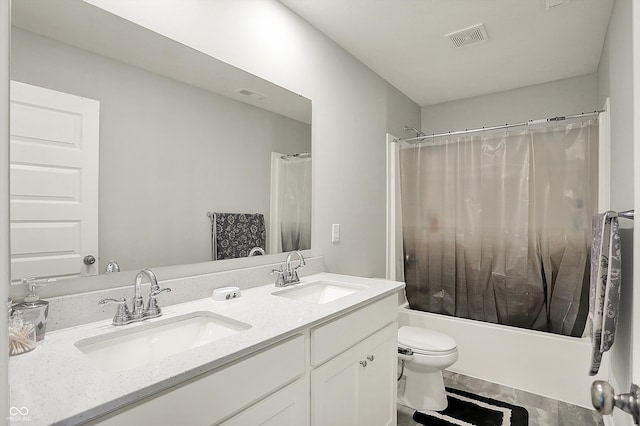 full bath featuring shower / bath combo, visible vents, a sink, and double vanity
