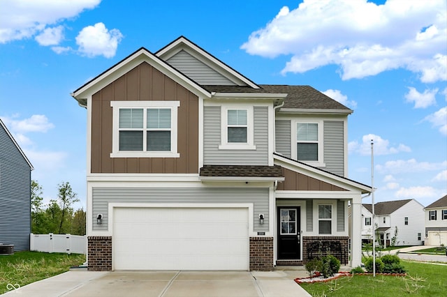 craftsman inspired home with concrete driveway, an attached garage, brick siding, and board and batten siding
