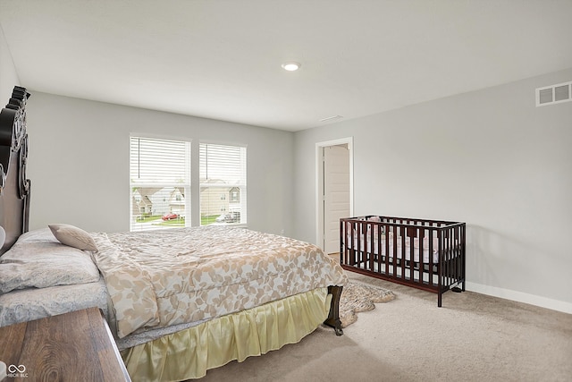 carpeted bedroom featuring baseboards, visible vents, and recessed lighting