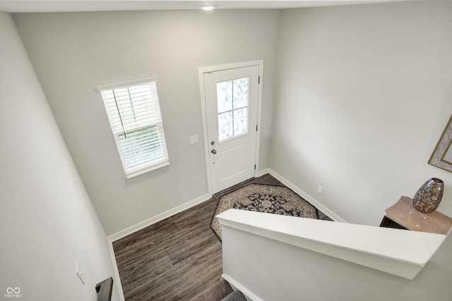 entryway featuring dark wood finished floors and baseboards