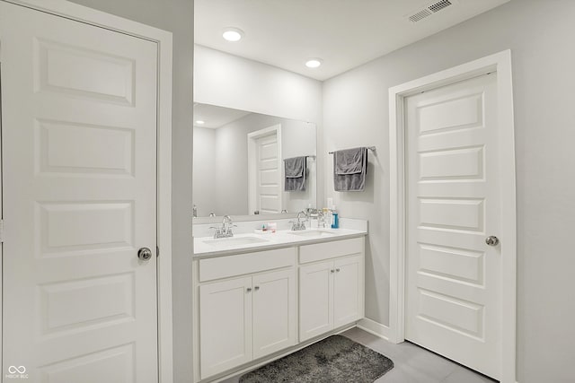 full bathroom with tile patterned flooring, visible vents, a sink, and double vanity