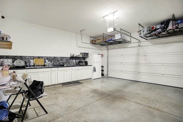 garage with freestanding refrigerator and a garage door opener