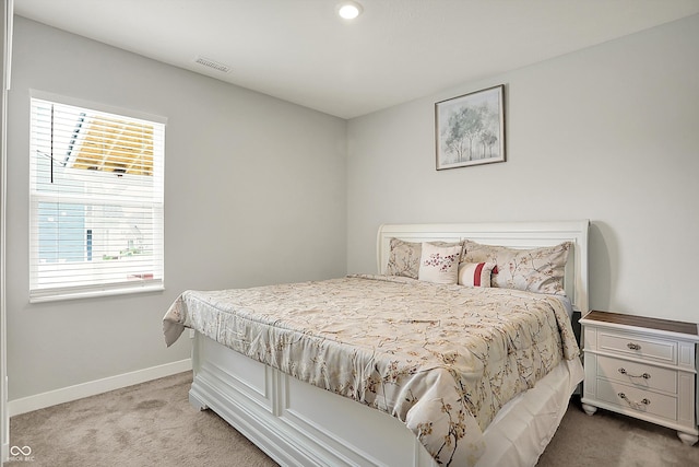 carpeted bedroom featuring baseboards, recessed lighting, and visible vents