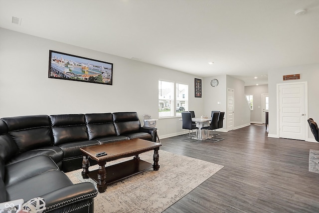 living area featuring dark wood finished floors, baseboards, and recessed lighting
