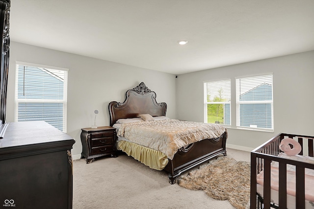 bedroom featuring light colored carpet, baseboards, and recessed lighting
