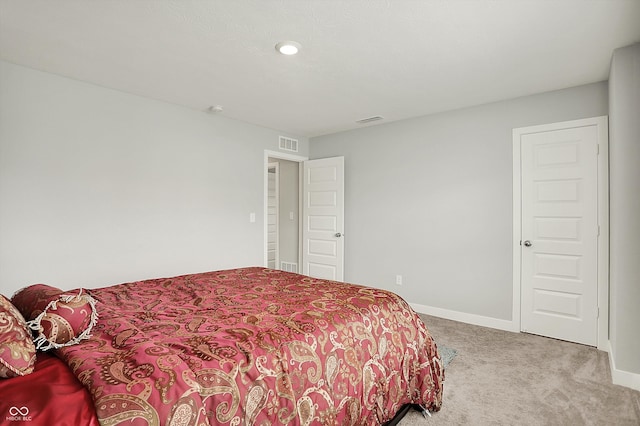 carpeted bedroom featuring baseboards, visible vents, and recessed lighting