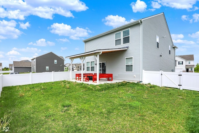 rear view of property featuring a gate, a patio area, a fenced backyard, and a yard