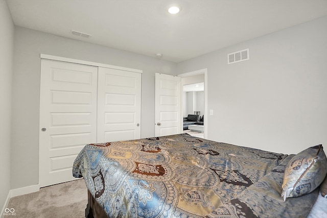 bedroom featuring baseboards, carpet floors, a closet, and visible vents