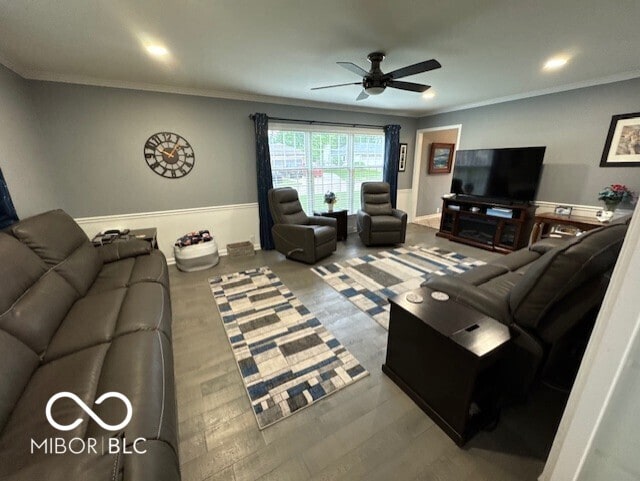 living area featuring ceiling fan, ornamental molding, wood finished floors, recessed lighting, and wainscoting