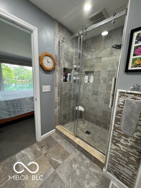 full bathroom featuring ensuite bathroom, a stall shower, and baseboards